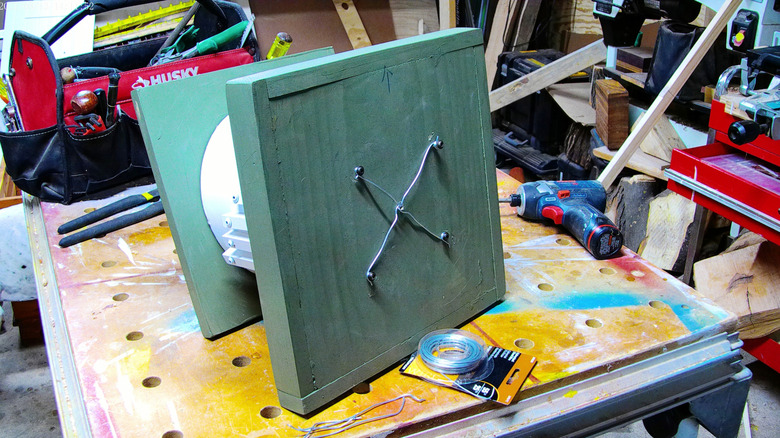 Bottom of a birdfeeder with wires secured by panhead screws