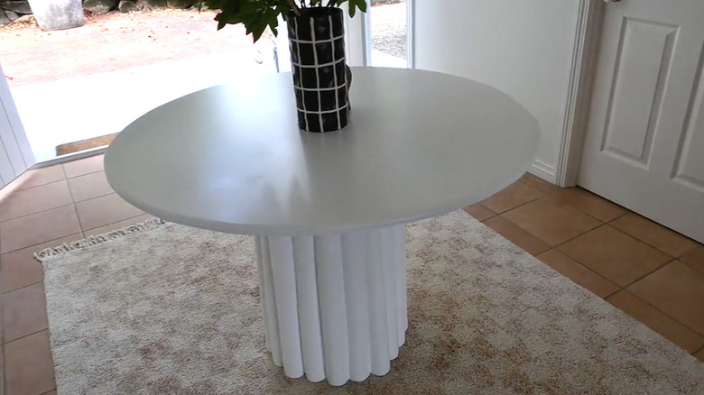 A white table made out of pool noodles