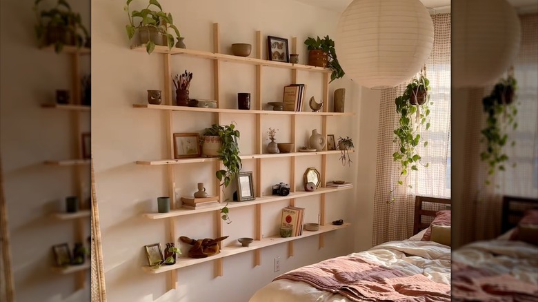 floating gridded wood shelving unit on a bedroom wall with decor, plants, and books