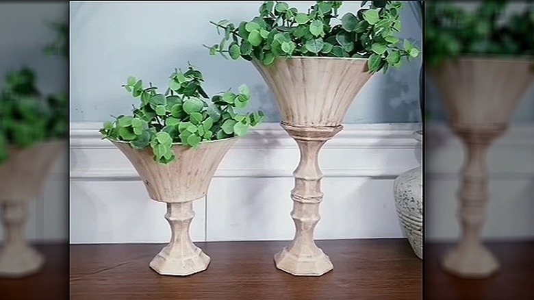 The final DIY vintage-style planters with fake greenery.