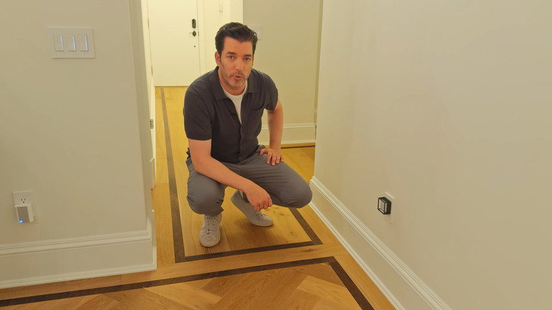 Jonathan Scott smiles during in front of a Swiffer backdrop