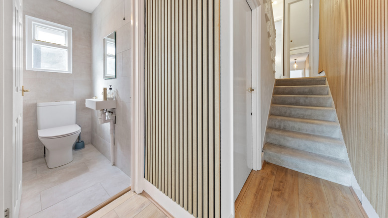 Three different flooring types in a toilet, hallway, and staircase