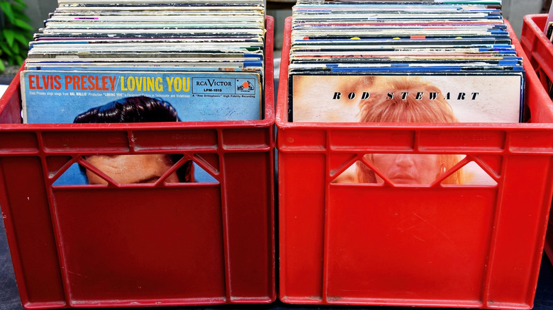 A pair of milk crates that are full of vinyl records