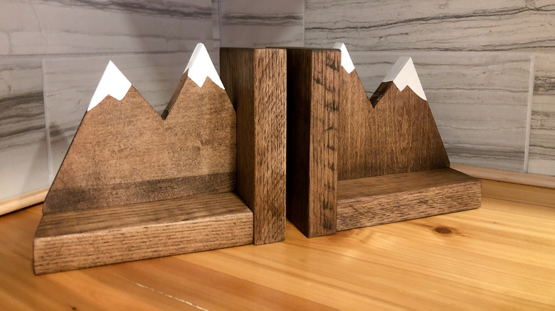 Pair of wood bookends with a mountain design on a countertop