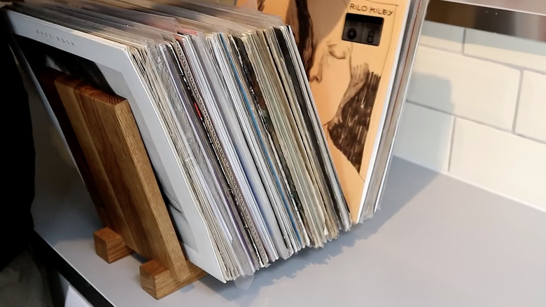 Full wooden vinyl record stand sitting on top of a cabinet