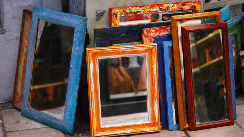 A collection of old framed mirrors at a flea market