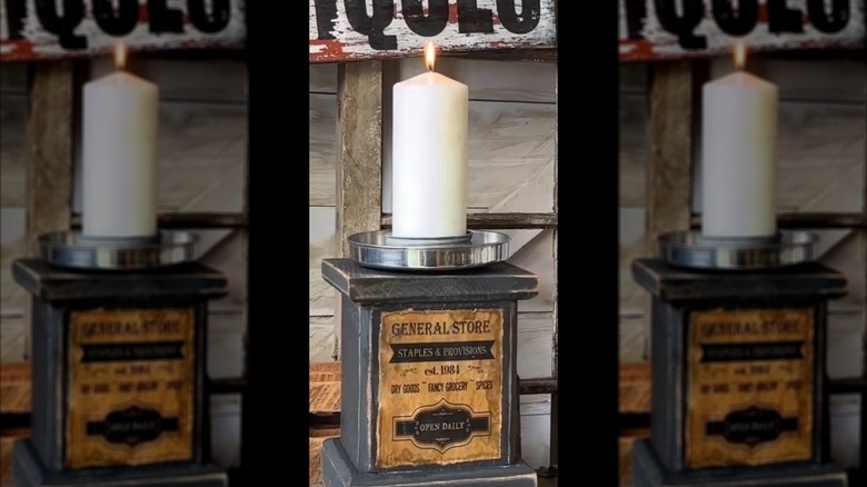 Vintage DIY candle holder with off-white pillar candle with rustic backdrop and old-fashioned general store label