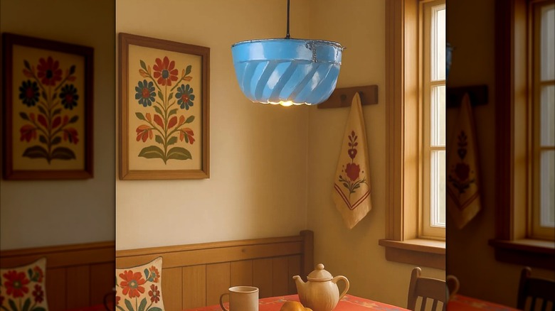 Blue Bundt cake pan repurposed into pendant ceiling light above classic floral breakfast nook with window