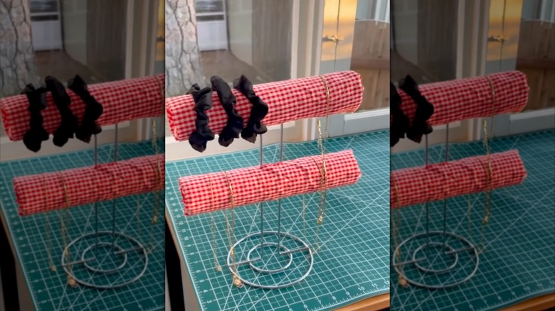 A DIY pool noodle jewelry organizer on a table