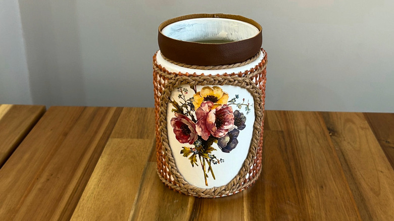 Jar covered in nonslip rug backing with floral design on it