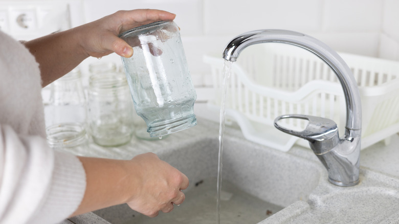 hands washing glass jar for reuse