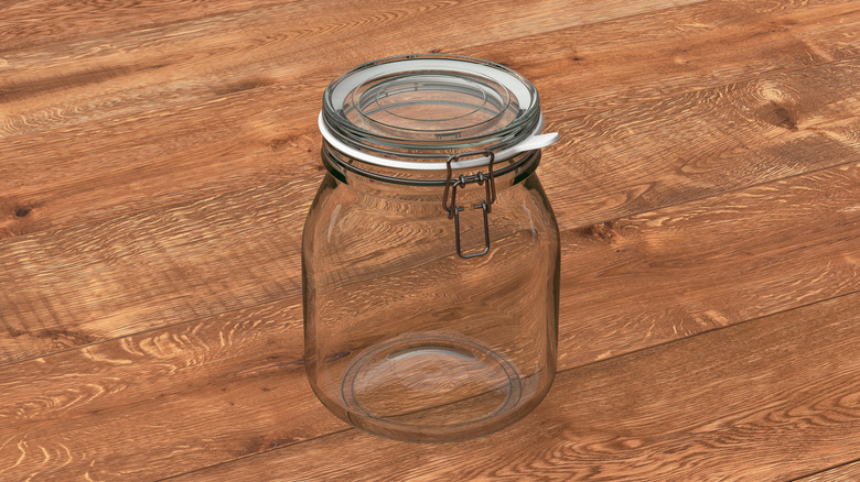 An empty glass jar on a wood table