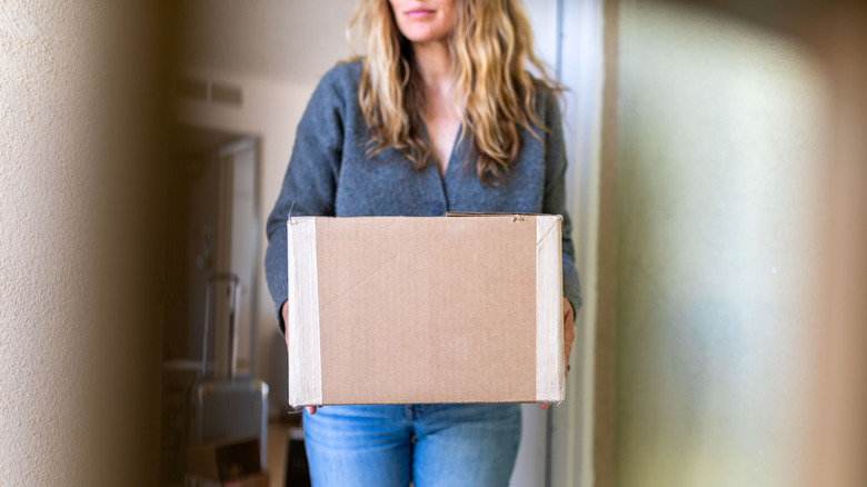 Woman holding an old cardboard box