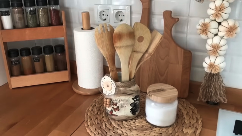 Finished DIY jar holding cooking utensils on a kitchen counter.