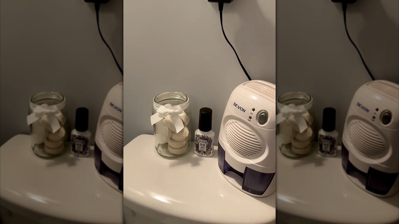 pickle jar with ribbon as bathroom storage
