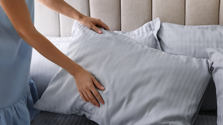 Woman holding a blue pillow