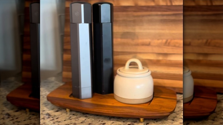 Refurbished thrifted wood tray with feet holding sugar bowl and salt and pepper shakers