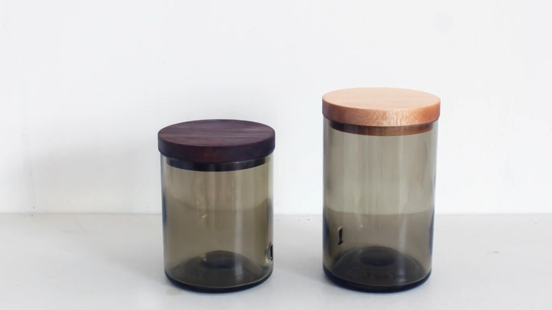 Two glass jars with wooden lids, made from old glass bottles