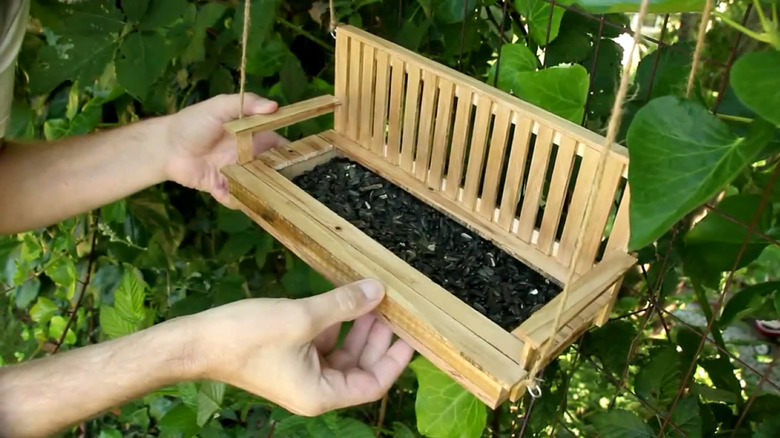 Ramsey holding DIY swing bird feeder