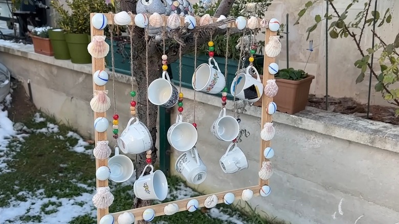 Old tea cups turned into a whimsical outdoor decor piece