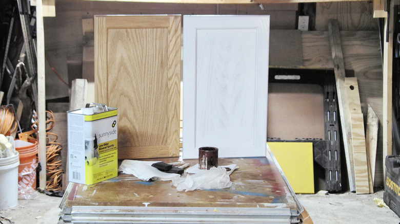 Two cabinet doors with a basic finish and tools in front of them