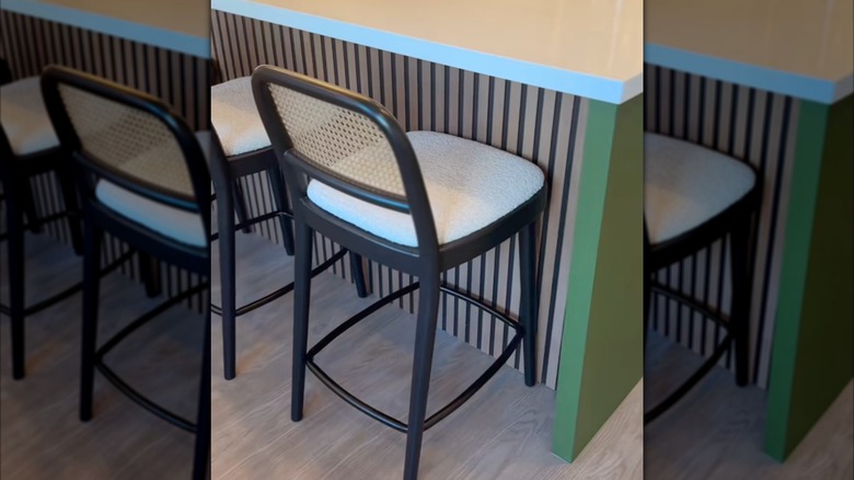 Kitchen island with vertical wood slat panels installed on the rear underside for a modern detail