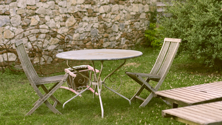 old lawn furniture in grass