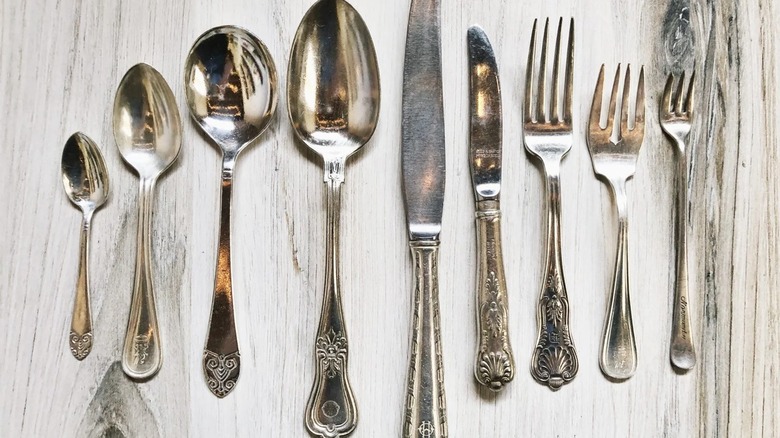 A collection of hotel silver flatware on a table
