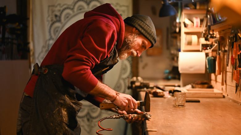Man working on project on wood work bench