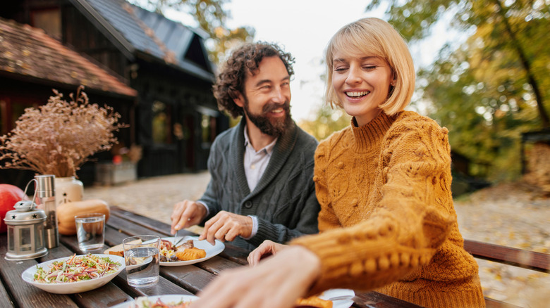 Couple dining outside on a patio.