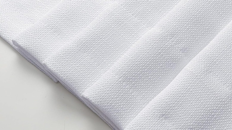 Close-up of white 100% polyester curtain material for dishwashers