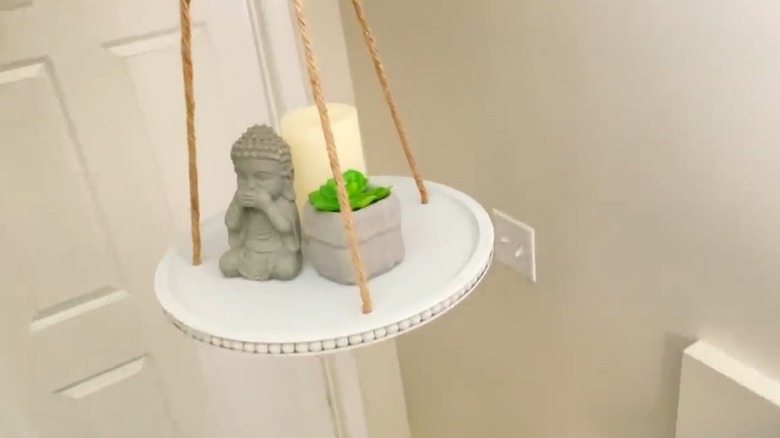 A hanging display tray made from Dollar Tree pizza pans