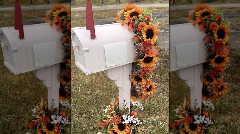 A fall floral arrangement in a garland draped around a mailbox