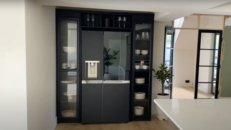 IKEA BILLY bookshelves with OXBERG glass doors transformed into a custom built-in fridge surround