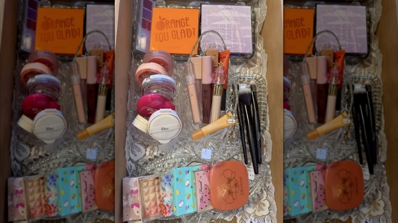 A cosmetics drawer lined with lace doilies