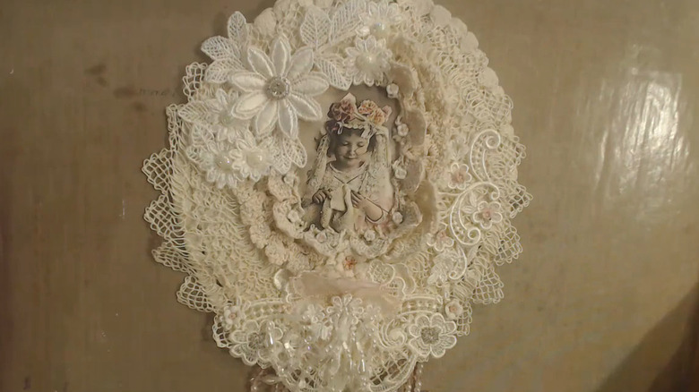 DIYer shows off a doily wall decoration she created