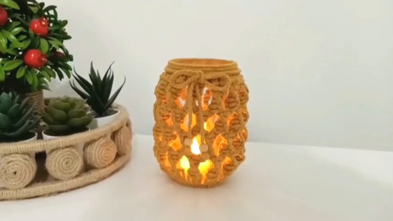 Glass jar decorated with rope with a light inside