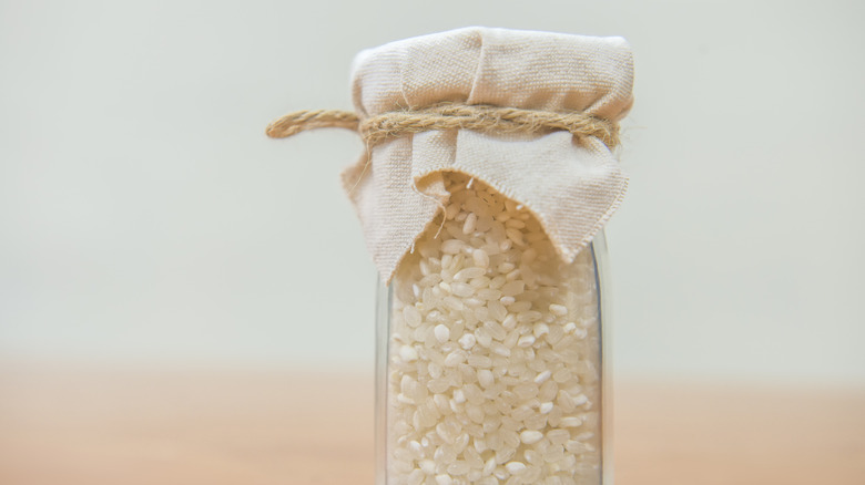 Rice in a glass jar covered with fabric and tied with twine