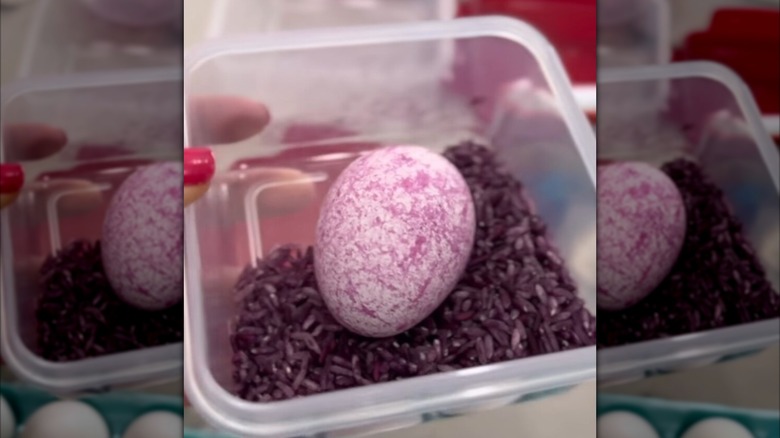 container with dyed rice and egg