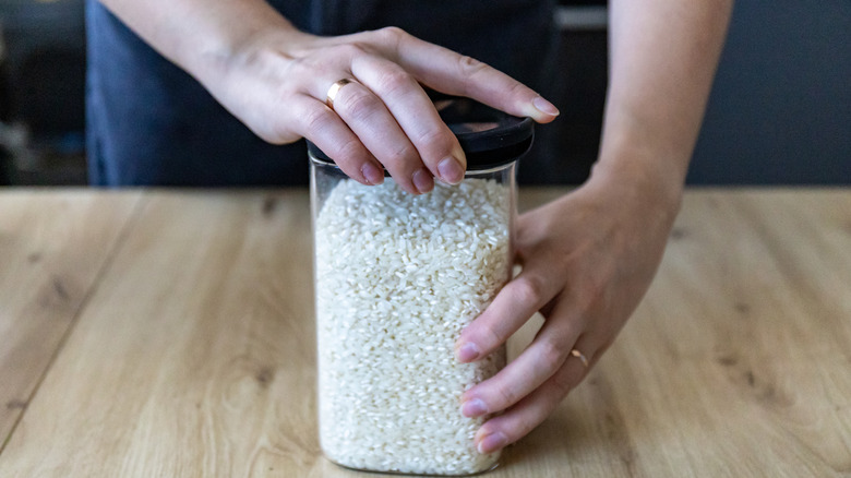 woman opening jar of rice