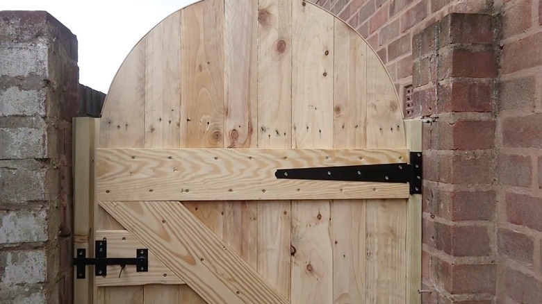 A garden gate built out of reclaimed pallet wood