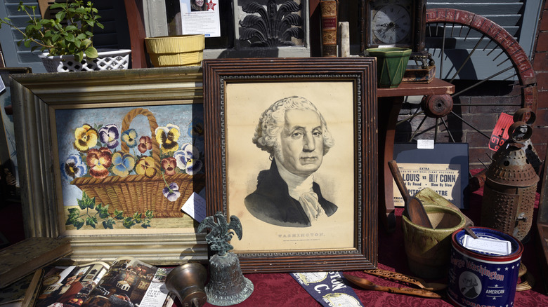 A collection of antique lithographs, curios, and paintings on display