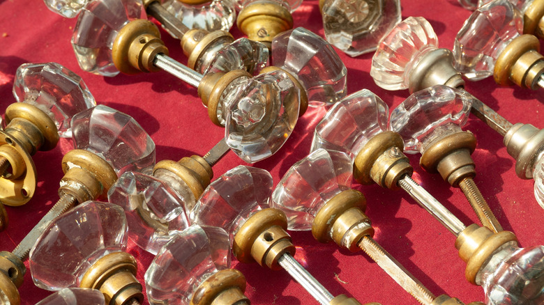 A collection of vintage glass doorknobs are shown in a detail shot