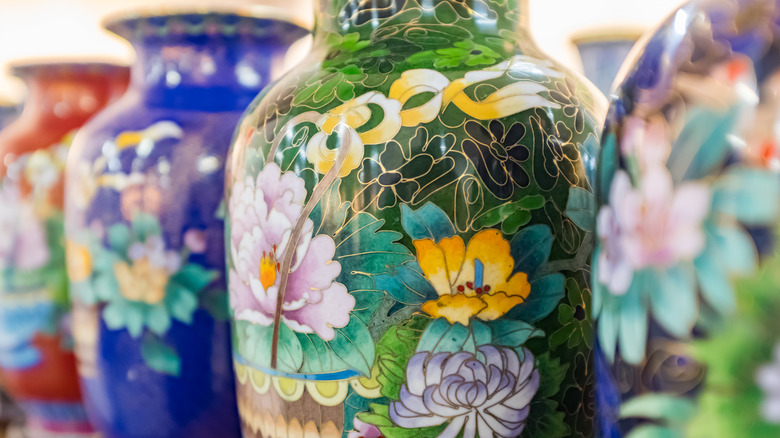 Colorful cloisonné vases sit next to each other