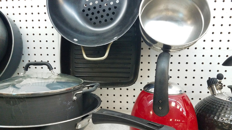 A series of pots and pans at a thrift store.