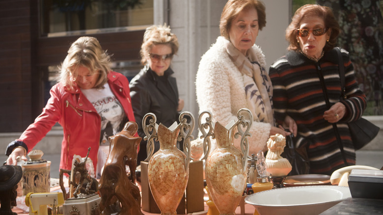 A group of women browsing at a secondhand market.
