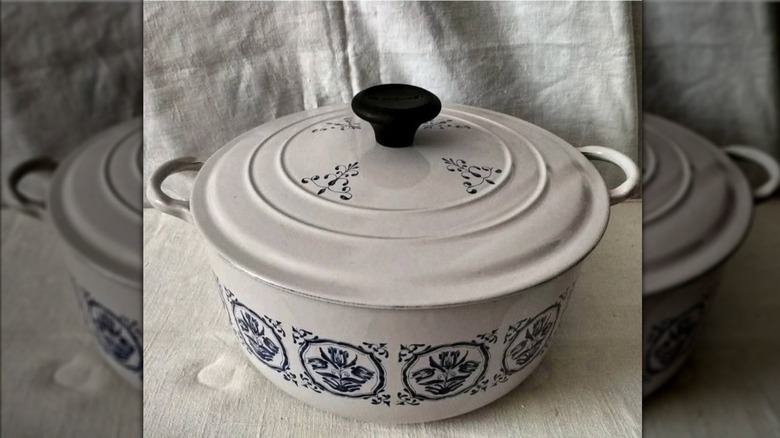 A vintage Le Creuset Dutch oven with a blue tulip print.