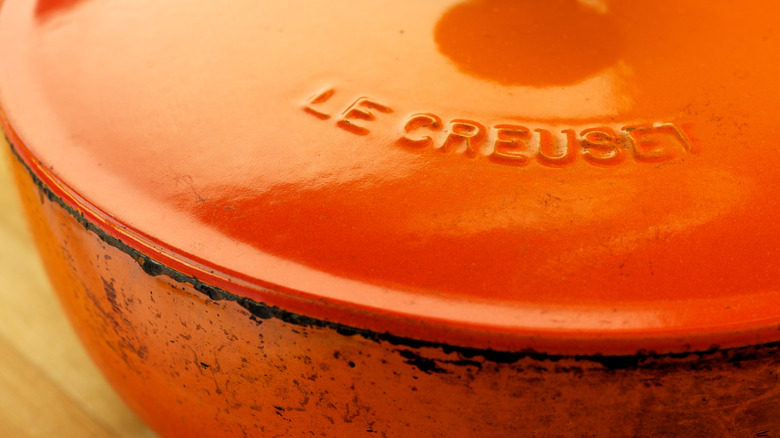 A bright orange Le Creuset dutch oven.