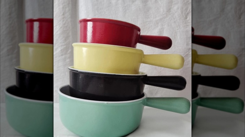 A set of four nesting Le Creuset pans in the Arlequin series