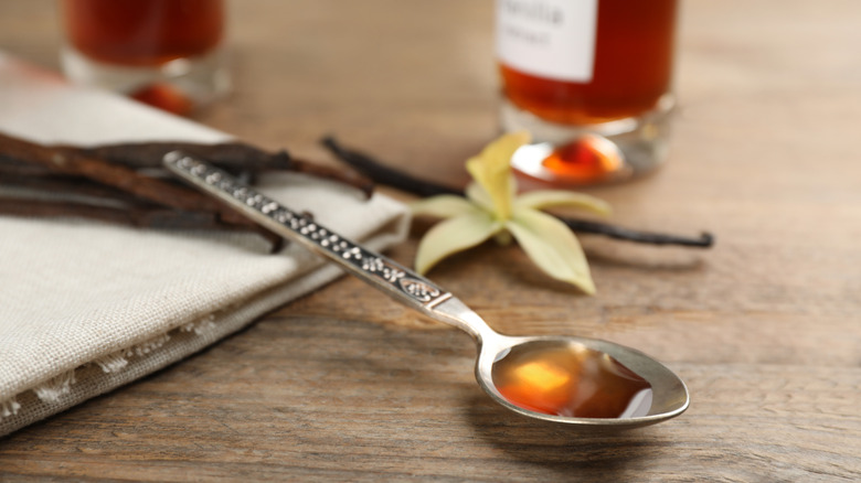 A spoonful of vanilla extract on a table.